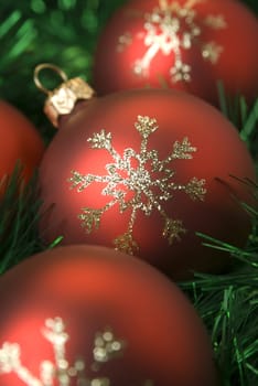 Red christmas balls on the green tinsel. Shallow dof, aRGB.