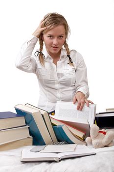 Schoolgirl or student ambarassed, she has been tackled from head. Books are left about around her. Isolated on white.