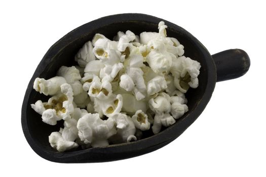popcorn on a rustic, dark painted,  wooden scoop, isolated on white