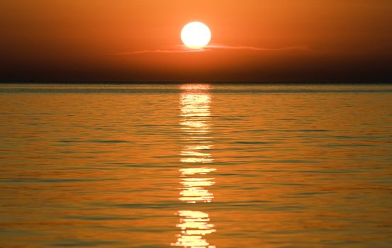 Sunset over the calm waters of the Adriatic sea, seen from Croatia towards Italy