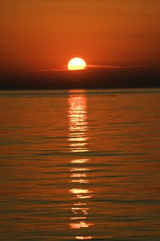 Sunset over the calm waters of the Adriatic sea, seen from Croatia towards Italy
