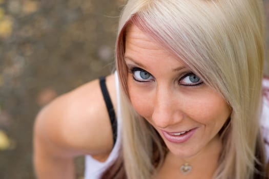 A closeup of a pretty blond woman from a higher angle.