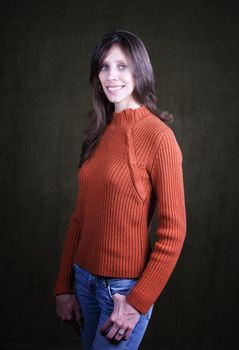 Pretty Young Woman Wearing an Orange Sweater and Wedding Ring