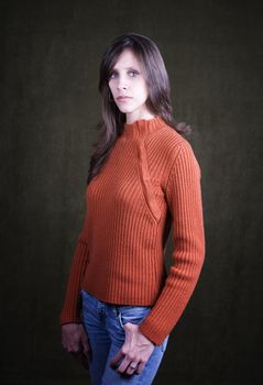 Pretty Young Woman Wearing an Orange Sweater and Wedding Ring