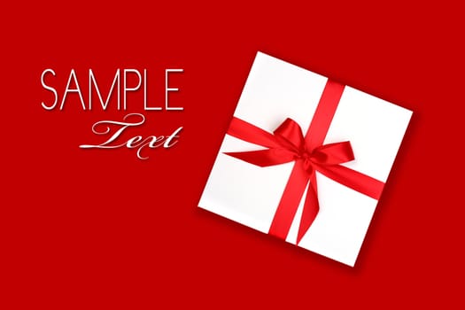Wrapped Holiday Gift With Red Ribbon and Bow on Red Background For Your Design