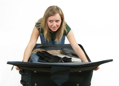 girl is packing clothes on bag