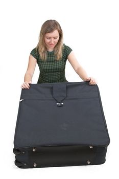girl is packing clothes on bag
