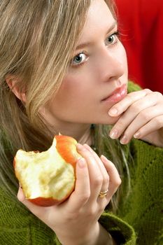 pretty girl is holding a juicy apple in  palm