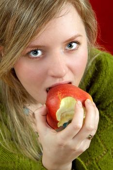 pretty girl is holding a juicy apple in palm