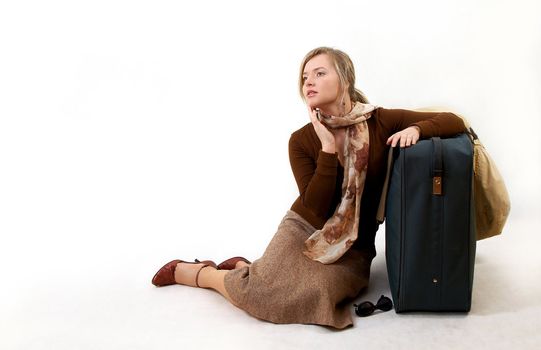 beauty woman with huge bag is siting on station, separate on white