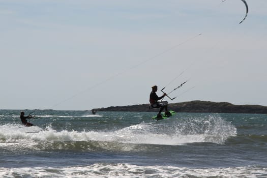 kite surfers in action on a windy day on the sea.