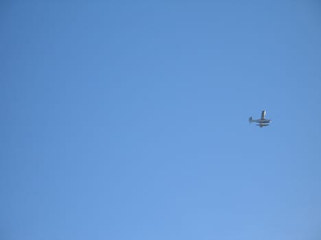 small airplane in the blue sky