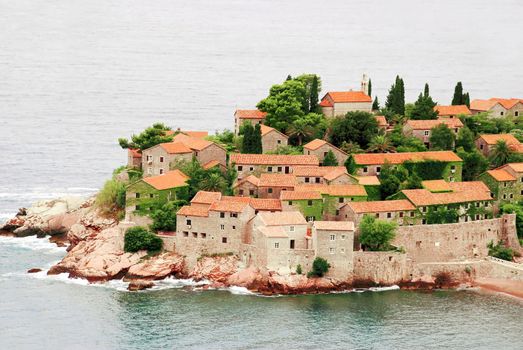 Island Sveti Stefan in Adriatic sea, stone houses tiled roofs