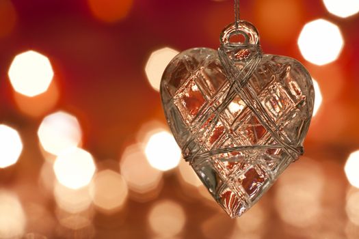 Christmas decoration - glass heart. Blurred lights background. aRGB.