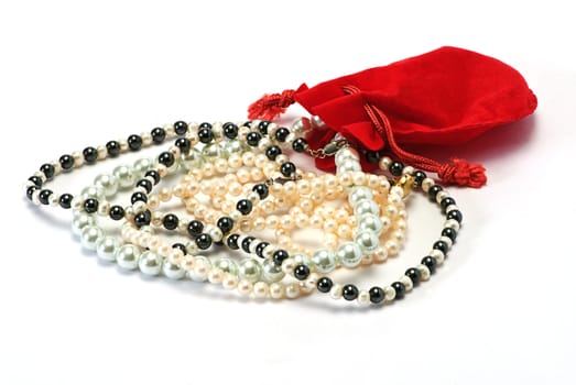 pearls and red pocket on white isolated