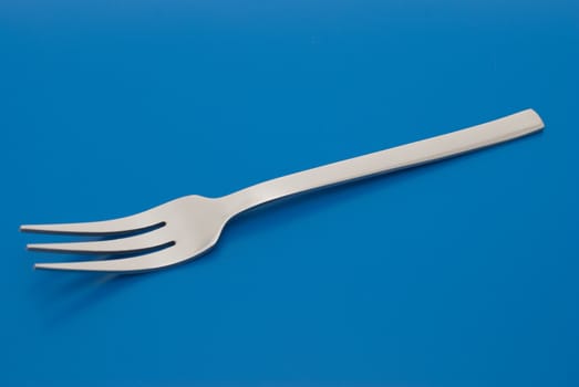 Barbecue table fork isolated on the blue background. isolated on the blue background.