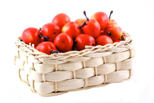Basket full of little red apples, isolated on white.          