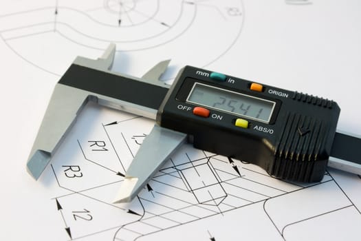 The electronic calliper lies on the detail drawing