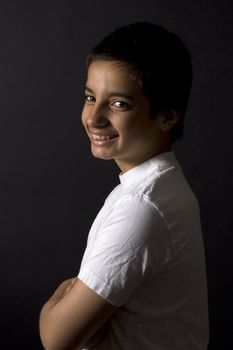 teenage boy is smiling on a black background