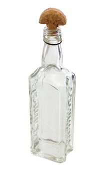 A transparent glass bottle with a wooden half-round cork standing on a table