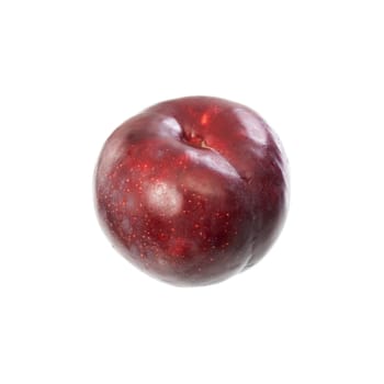 A ripe red plum lying on a table