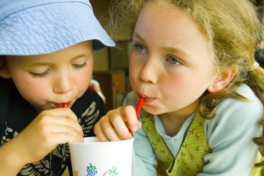 boy and girl sharing a drink