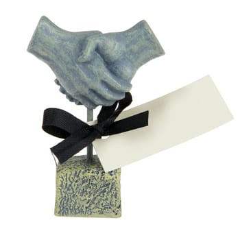 handshaking statue, made of stone, with a card