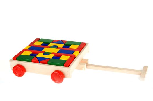 colorful building blocks in a trolley on a white background