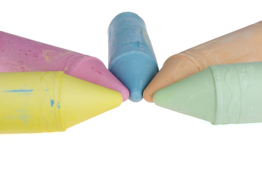 five colorful chalks on a white background