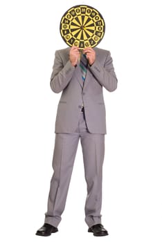 Full body view of a businessman hiding his face behind a dartboard