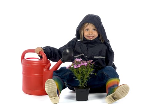 a boy is giving the plants some water