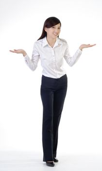 Full length portrait of worried business woman open arms and stand on white background.