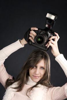 Pretty photographer with a professional camera and flash