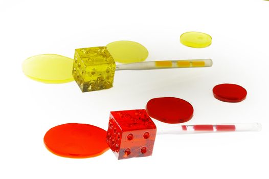 bounch of colorfull translucent dice shaped lollipops backlit on white background