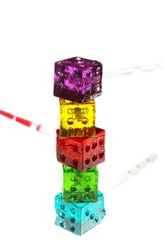 bounch of colorfull translucent dice shaped lollipops backlit on white background