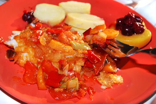 fried vegetables on red plate with fork