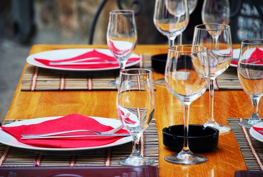 wineglasses and plates on table in restaurant