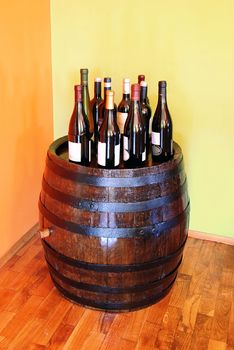 bottles of wine over wooden barrel indoor