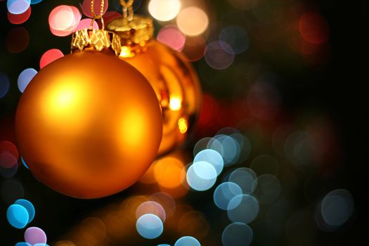 christmas balls hanging in front of the christmas tree