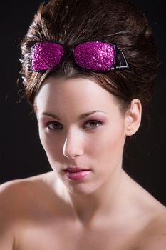 Beautiful girl with pink sunglasses on her head