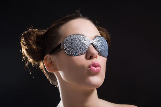 Pretty brunette with weird sunglasses in the spotlight
