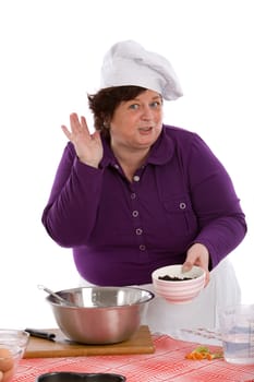 Happy chef making a good tasting gesture with a bowl in her hands