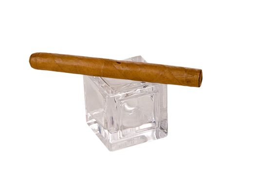 long brown havana cigar on glass cube