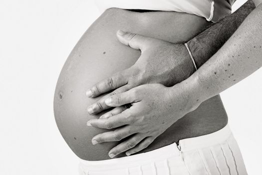 Husband holding the beautiful belly of his pregnant wife