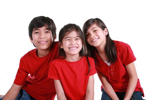 Three siblings with red shirts isolated on white