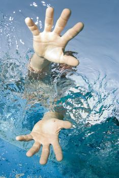 Underwater view of a sailor reaching into the water