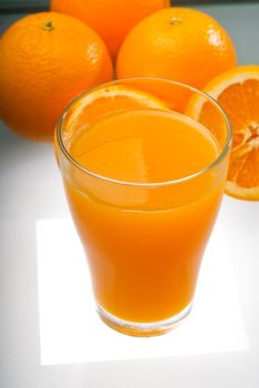 fresh and healthy orange juice ,unfiltered ,over a light table