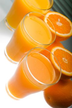 fresh and healthy orange juice ,unfiltered ,over a light table