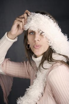 Pretty woman posing with a kiss and a fuzzy scarf