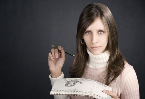 Pretty female artist with pencil and drawing pad